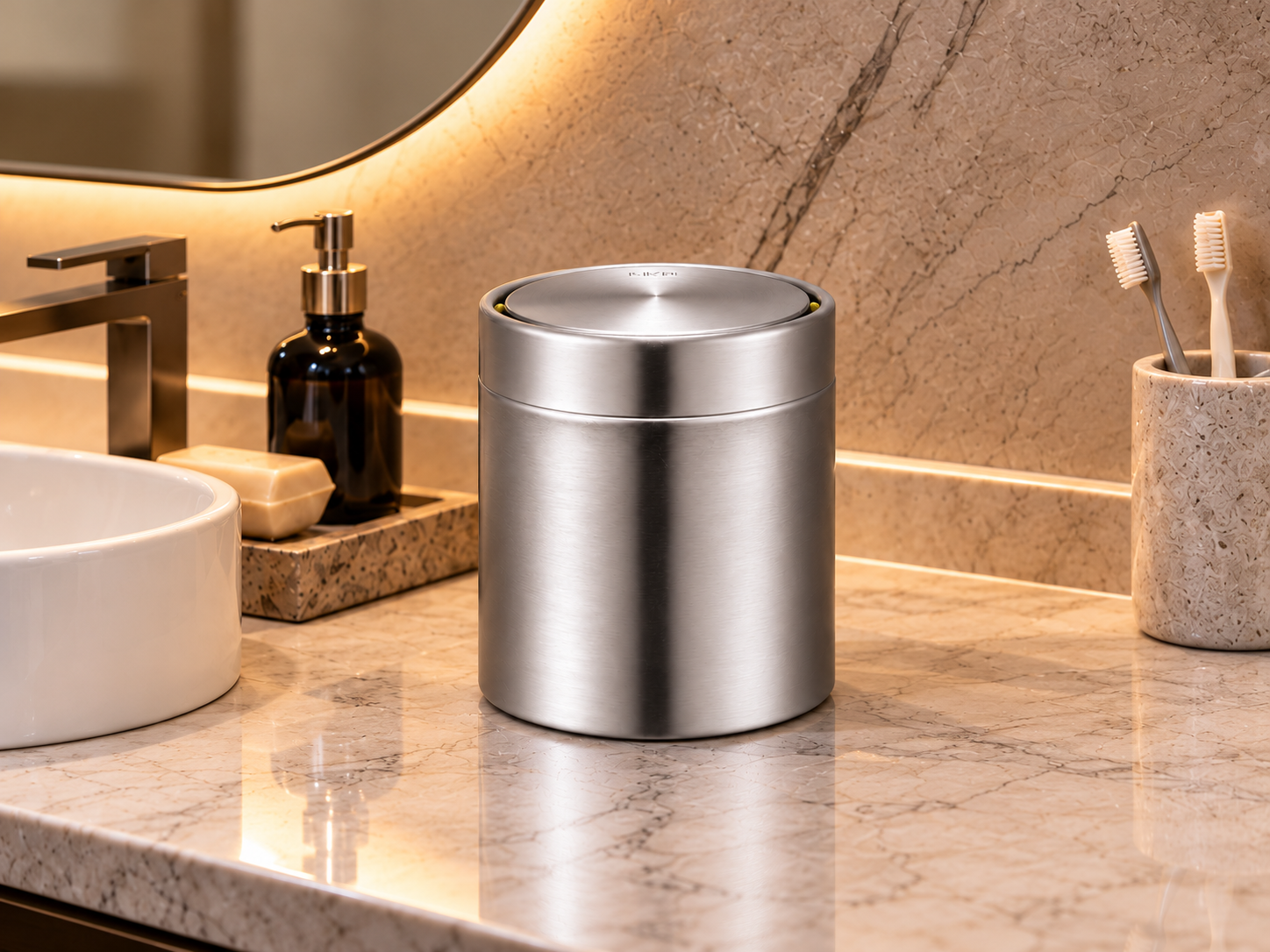 EKO Fandy Table Bin – Luxury Bathroom Vanity EKO Fandy 1.5L stainless steel table bin on a marble bathroom vanity with elegant accessories and warm ambient lighting.